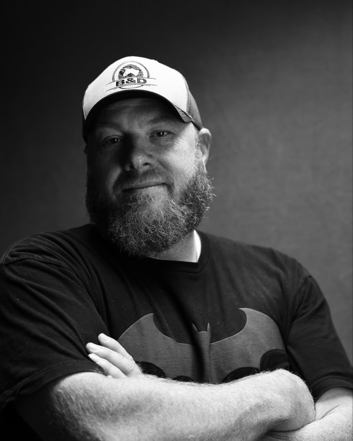 Black-and-white portrait of Brent Weber, arms crossed