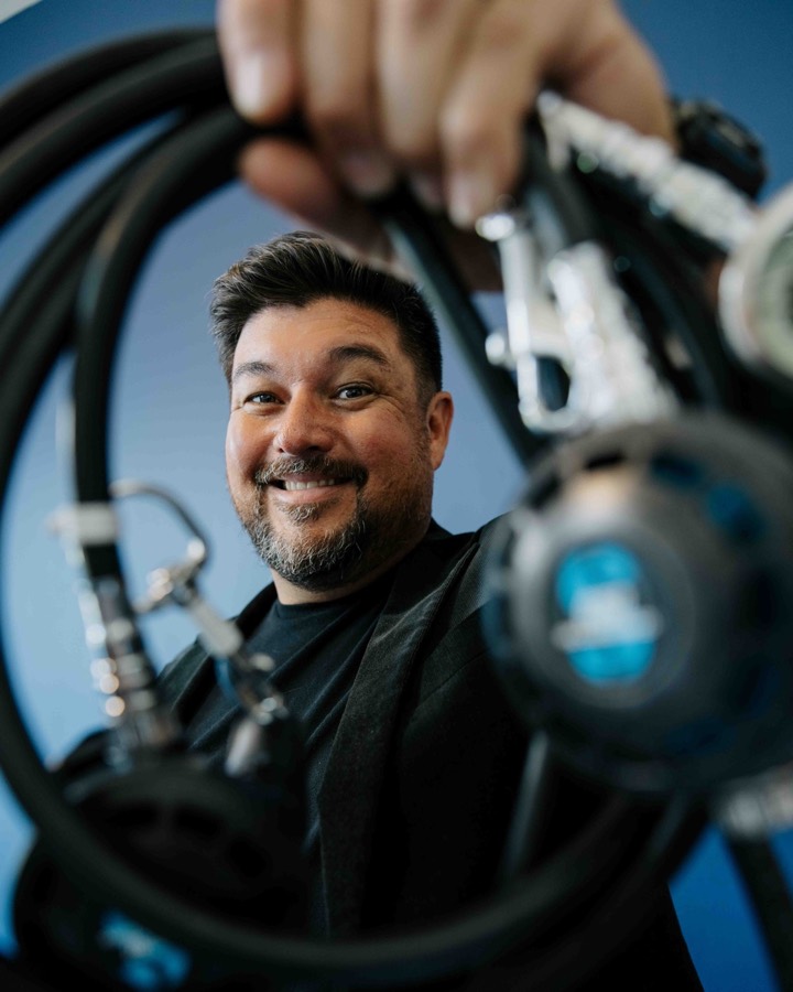 Jeremiah Gardner holding a cave-diving regulator